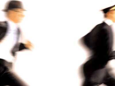 A picture of 2 men running depicting the issue of legacy booking systems disclosing travelers’ private information.