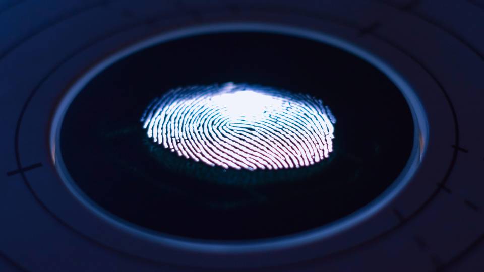 A picture of a fingerprint on an optical scanner that depicts banks are known for their strong security efforts and better-than-average protection from hacking