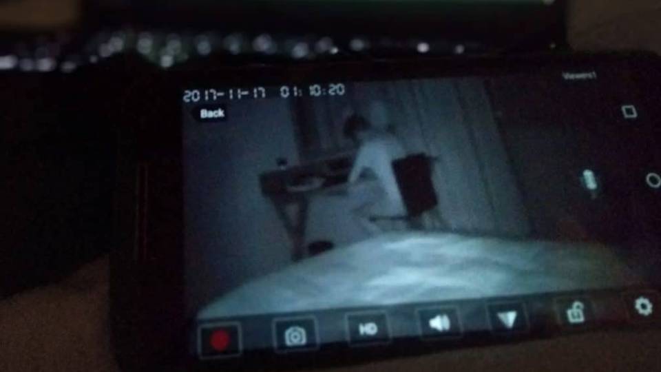 A picture of an exposed private camera showing a man in his room working attached to a blog article about how the cloud exposes private IP cameras.