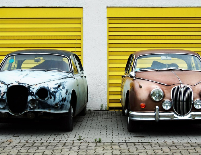 The picture shows two cars being benchmarked against each other, one is old and rust, and the other one is a newer and cleaner version of the same car. The photo depicts the importance of comparing cyber security posture over time. It is attached to an article explaining 5 easy steps companies can follow to benchmark their cybersecurity posture.