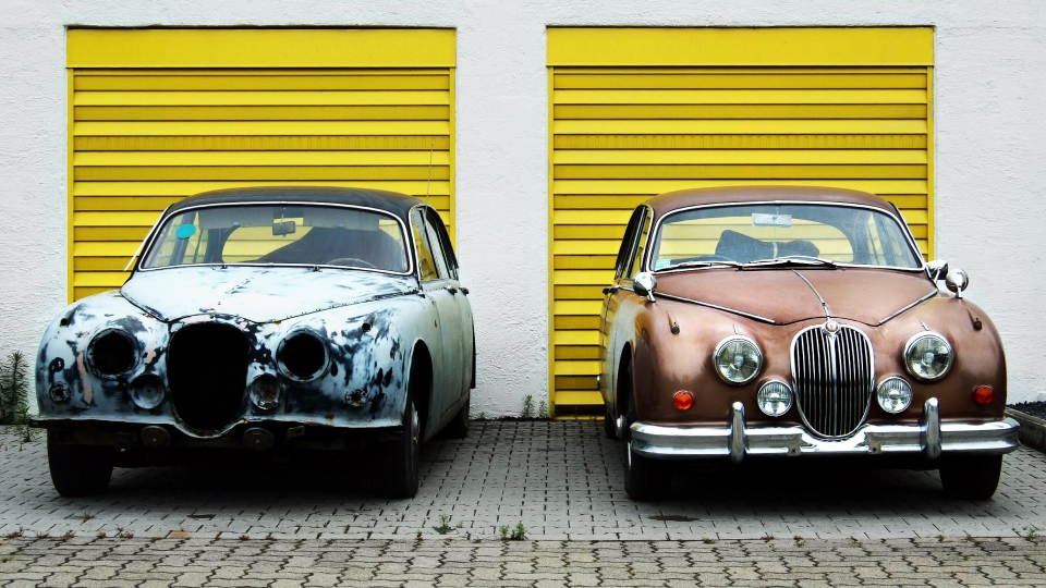 The picture shows two cars being benchmarked against each other, one is old and rust, and the other one is a newer and cleaner version of the same car. The photo depicts the importance of comparing cyber security posture over time. It is attached to an article explaining 5 easy steps companies can follow to benchmark their cybersecurity posture.